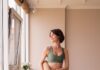 바쁜 일상 속 필라테스, 내 몸과 마음을 위한 작은 변화 a woman in a green sports bra top and leggings holding a yoga mat