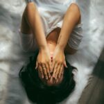 스트레스, 내 일상에서 가볍게 푸는 법…“작은 습관이 큰 변화를 만든다” a woman holds her hands over her face